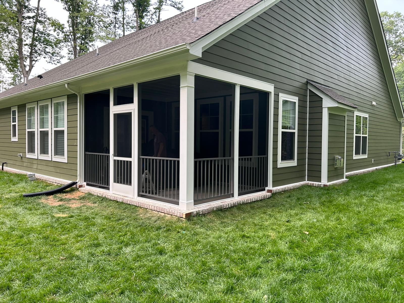 This project created a screened in porch from an existing rear patio. The rails were built with white Westbury composite wood for a home in Chesterfield, VA