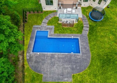 This pool build project included installation of an inground liner pool with stamped concrete patio and steps, and exterior LED lights. Glen Allen, VA