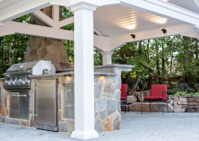 outdoor kitchen installation with custom counters, pavilion and lighting