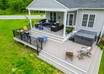 Construction of a covered composite backyard deck with railing, tying into a walkway to an inground pool | cleanstone construction | richmond, va