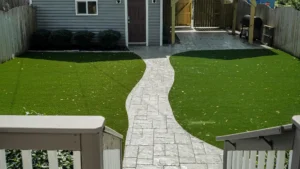 stamped concrete walkway to front door of house.