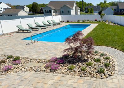 rectangle fiberglass pool in backyard.