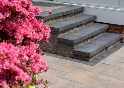 Stone Steps on paver patio up to house.