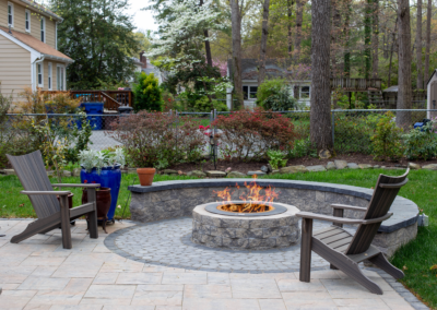 Circular stone firepit with wall for seating area.
