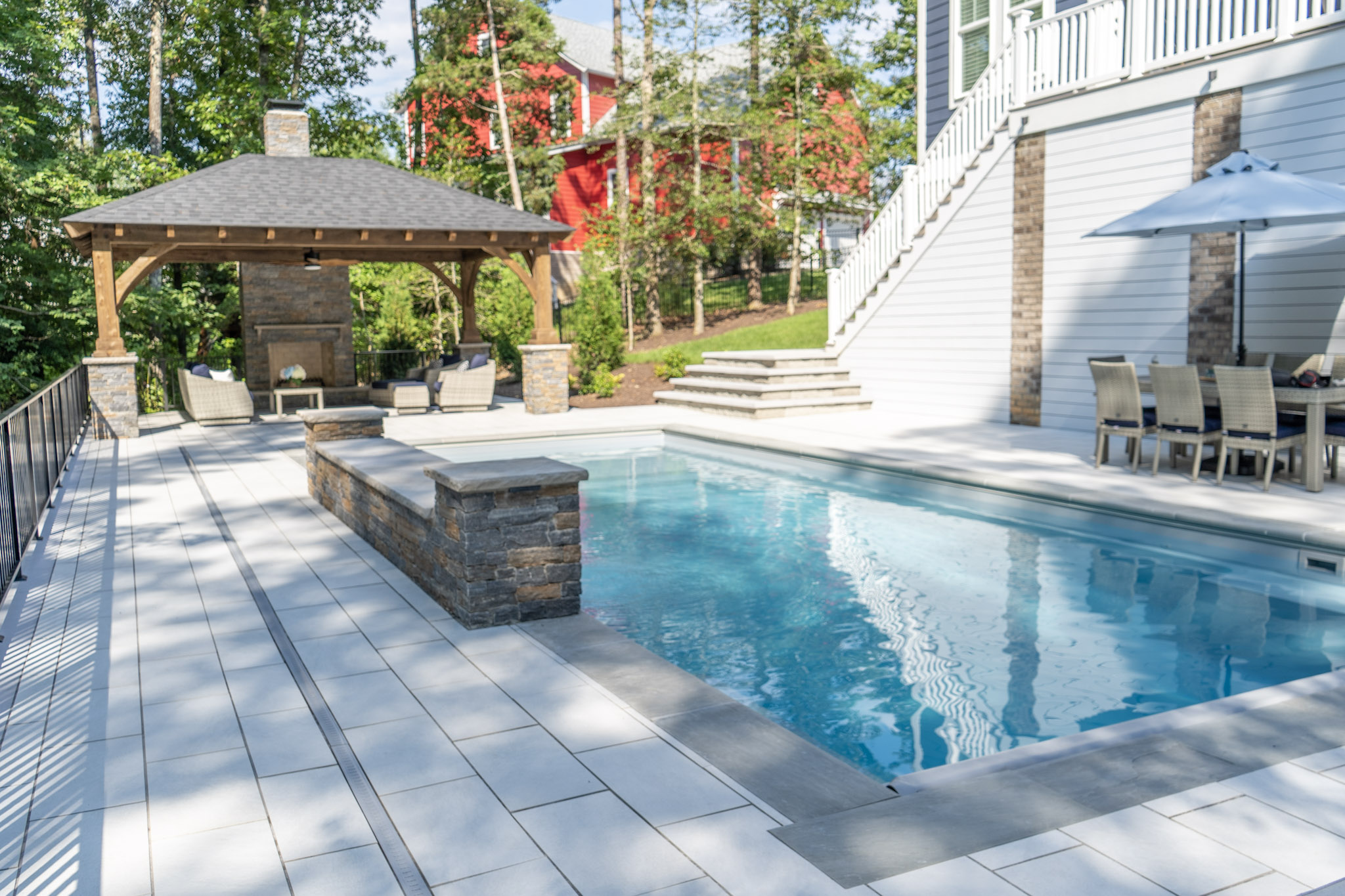 We build this custom composite decking project with engineered wood to provide poolside outdoor living and dining space for a home in Richmond, Virginia.